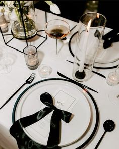 the table is set with black and white place settings