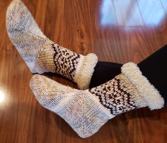 two pairs of socks sitting on top of a wooden floor