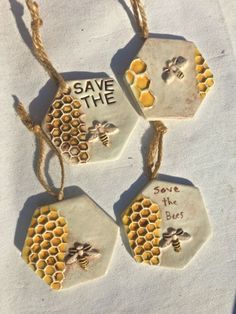 four ceramic tags with bees and save the bees written on them