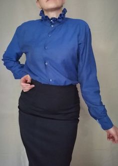 Vintage 80s blue ruffle collar botton down blouse whit red bottons , simple elegant long sleeve top, office outfit ,Ladies blouse M Bust: 100cm / 39 in Lenght:  63 cm/ 24 in Sleeve lenght: 62 cm/ 23 in Size : M-L Materials: 100% cotton Condition: very good vintage condition See more like this in my shop: https://www.etsy.com/shop/VintageInsparation?ref=seller-platform-mcnav  BUY 2 ITEMS GET 15% off   BUY 3 ITEMS GET 25% off Cheap Blue Collared Blouse, Affordable Blue Collared Blouse, Collared Blue Blouse Affordable, Blouse Simple, Ladies Blouse, Office Outfit, Ruffle Collar, Simple Elegant, Office Outfits