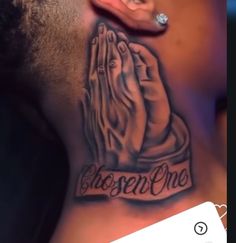 a man with a black and grey tattoo on his chest holding the word chosen one