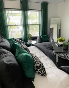 a living room filled with furniture and green curtains