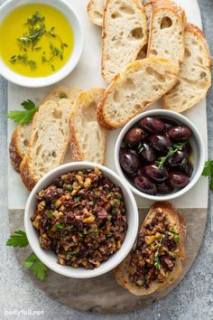 bread, olives and other foods are on a plate