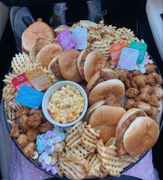 a platter filled with chicken, waffles and other foods