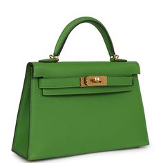 This tiny Kelly is in Vert Yucca epsom leather with gold hardware, has tonal stitching, two front straps with front toggle closure, single rolled handle and removable shoulder strap.The interior is lined with Vert Yucca leather and has one open pocket on the back wall.Collection: BOrigin: FranceCondition: New and never worn (plastic on hardware) Accompanied by: Hermès box, Hermès dustbag, shoulder strap, shoulder strap dustbag, felt, carebookMeasurements:﻿ 7.5" width x 4.5" height x 2.2" depth; 2.5" handle drop, 18.5" Shoulder Strap Drop Luxurious Closet, Hermes Kelly Sellier, Gold Bags, Kelly Sellier, Hermes Kelly Bag, Green Things, Hermes Box, Kelly Bag, Vintage Hermes