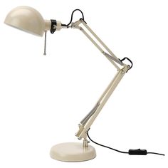 a white desk lamp sitting on top of a table