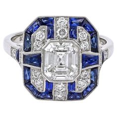 A Sophia D. ring that features a 1.03 carat center diamond accented with 1.09 carats of blue sapphires and 0.27 carats of diamonds. Set in platinum. Sophia D by Joseph Dardashti LTD has been known worldwide for 35 years and are inspired by classic Art Deco design that merges with modern manufacturing techniques. Ascher Cut, Most Popular Engagement Rings, Popular Engagement Rings, Trending Engagement Rings, Art Deco Diamond Rings, Ring Trends, French Cut, Estilo Art Deco, 18k Yellow Gold Ring