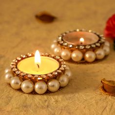 two small candles sitting on top of a table