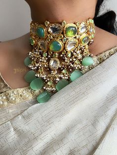 Green Sabyasachi Bridal Jewelry Set. This is an elegant Kundan necklace with the most stunning festoon. The perfect accessory for your occasion. This necklace is handcrafted with love * Necklace Length: 16 inches (comes with adjustable Dori/cord) * Earrings Length: 3 inches approx * Maangtikka: Freesize * Package: Necklace, earrings & mang tikka * Material: Pearl, brass, and stone * Care: Store in an airtight plastic bag or box. Keep away from water, moist place & fragrance STYLE TIP: This necklace is a perfect accessory for any type of occasion, wedding, and celebration. They look good with Rich and royal attire like banarasi sarees and lehengas ABOUT US: Jaipri makes each piece of its product by learning techniques and crafts from deep down in the local markets and villages. We use India Luxury Bohemian Kundan Necklace With Intricate Design, Luxury Elegant Multicolor Kundan Necklace, Luxury Multicolor Kundan Necklace, Luxury Exquisite Hand Set Kundan Necklace, Luxury Green Kundan Traditional Wear, Luxury Green Cutdana Bridal Necklace, Luxury Multicolor Kundan Necklace For Ceremonial Occasions, Luxury Green Kundan Necklace With Stones, Luxury Green Kundan Necklace For Festive Occasions