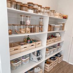 an organized pantry with lots of items on the shelves and baskets in front of it