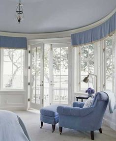 a bedroom with blue furniture and white walls