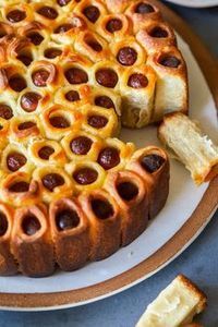 a hot dog bun on a plate with some slices cut out and ready to be eaten