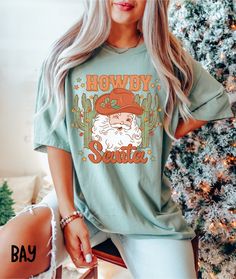 These Comfort Colors Cowboy Christmas tees are sure to get you in the holiday spirit! They're comfy, cozy, and OH SO CUTE!  Would make a fabulous gift for anyone on your list, and would be a hit at holiday parties!  Wear it baking cookies and watching Christmas movies or head out shopping, tree picking, or to see Christmas lights!  No matter where the holiday season takes you, you'll love it!  Thanks for stopping by! Shirts are Adult Unisex sizing and they are soft and cozy Rolled Sleeves in pic Snow White Shirt, Thanksgiving Baby, Comfort Colors Tshirt, Cow Shirt, Thanksgiving Shirt, Comfort Colors Tee, Christmas Tees, Look Plus, Retro Christmas