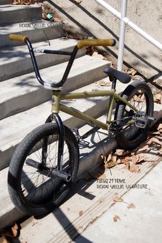 a green bike sitting on top of some steps