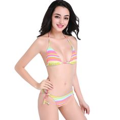 Get ready to make a bold fashion statement at the beach or poolside with our stunning 2023 New Rainbow Striped Lace-up Nylon Bikini Swimsuit. This eye-catching two-piece swimsuit features vibrant rainbow stripes that will instantly elevate your summer style. The unique lace-up design adds a touch of trendy flair, ensuring you stand out from the crowd. Made from high-quality nylon fabric, this bikini offers a comfortable and flattering fit, allowing you to move with ease while enjoying your time Beachwear Swimwear With Triangle Top And Lined Body, Multicolor Lined Swimwear, Multicolor Lined Swimwear For Swimming, Multicolor Lined Swimwear For Vacation, Sunbathing Multicolor Lined Tankini, Multicolor Lined Tankini For Beachwear, Multicolor Tankini For Sunbathing, Multicolor Tie-side Swimwear For Beach Party, Multicolor Tankini For Sunbathing With Lined Body