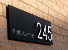 a black and white sign on a brick wall that says park avenue, with the number twenty five