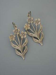 "Vintage Jewelry - Vintage Earrings - Flower Earrings - Flower Jewelry - Brass Earrings - Chloe's Vintage handmade jewelry Such pretty earrings! Vintage brass floral design drops. Would make nice Bridesmaids earrings. Chloe says, \"Wear them and feel fabulous!\" They measure 1 3/4\" long from the top of the ear wire Thanks for visiting Chloe's" Silver Flower-shaped Brass Earrings, Silver Brass Flower-shaped Earrings, Brass Flower Earrings For Wedding, Flower-shaped Brass Wedding Earrings, Silver Brass Flower Earrings, Metal Pierced Flower Earrings, Flower Shaped Chandelier Earrings For Gift, Brass Drop Earrings With Flower Detail, Silver Pierced Brass Flower Earrings