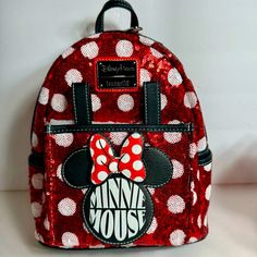 Nwt. Disney Minnie Mouse Sequin Polka Dot Loungefly Mini Backpack. Minnie's Signature Polka Dots Are Fashioned From Sparkling Red And White Sequins With Her Name On The Front. Simulated Leather Mini Backpack. Front And Sides Feature Red And White Sequin And Polka Dot Design. Approx. 10 1/2" H X 8 3/4" W X 4 3/4" D. Exterior Front Compartment With Simulated Leather Hinges. Simulated Leather Minnie Icon Appliqu On Front Compartment. Simulated Red Leather Back. Zip Closure With Double Zip Pull. Sid Cute Red Backpack For Disney Trips, Minnie Mouse Backpack For Disney Fan Events, Red Minnie Mouse Backpack For Disney Trips, Minnie Mouse Standard Backpack For Disney Trips, Minnie Mouse Backpack For Disney Trips, Minnie Mouse Loungefly Backpack, Red Minnie Mouse Bag For Disney Fan Events, Back To School Minnie Mouse Disney Bags, Back To School Disney Minnie Mouse Bag