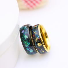 two rings with different designs on them sitting next to each other