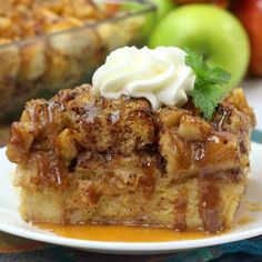 a slice of apple pie on a plate with whipped cream