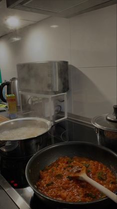 some food is being cooked in a pan on the stove and ready to be eaten