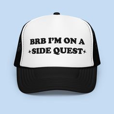 Introducing our "BRB On a Side Quest" Foam Trucker Hat – the perfect accessory for adventurers and gamers alike. This hat combines style and functionality, making it ideal for outdoor activities or simply showing off your love for gaming culture. The "BRB On a Side Quest" design adds a playful touch to your outfit, reflecting your passion for gaming and the thrill of embarking on exciting quests. The foam front and mesh back construction provide comfort and breathability, making it suitable for Trucker Hat With Short Brim For Outdoor Activities, Breathable Trucker Hat For Streetwear, One Size, Funny Trucker Hat With Curved Brim, Affordable White Funny Trucker Hat, Funny White Baseball Cap Trucker Hat, Cheap Funny Trucker Hat, Side Quest, New Journey, Dad Hats