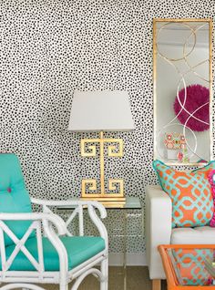 a living room filled with furniture and wallpaper covered in animal print wallsticks