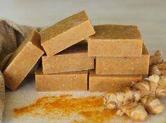 a pile of soap bars sitting on top of a counter next to ginger flakes