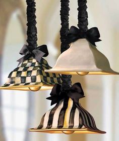 three bell shaped lights hanging from a ceiling