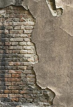 an old brick wall that has been torn down and is being used as a background