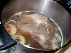 a pot filled with food sitting on top of a stove