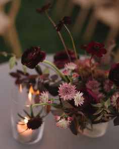 two vases filled with flowers on top of a table