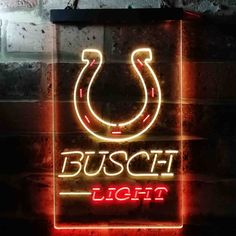 a neon sign that says busch light with a horseshoe in the center and an arrow on it