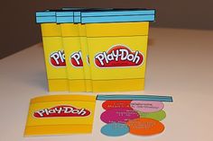 a play - doh box with stickers on the front and two discs next to it