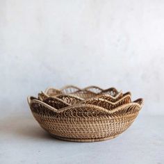 three woven baskets sitting side by side on a white tableclothed surface, with one empty basket in the middle