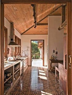 an open door leading to a kitchen with tiled floors