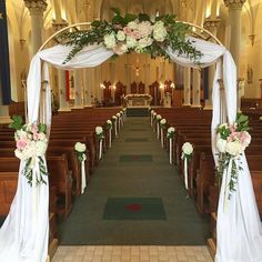 an aisle decorated with white and pink flowers