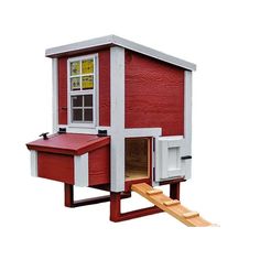 a red and white chicken coop with stairs