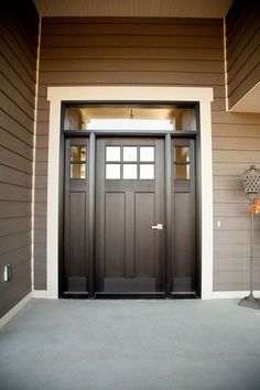 the front door of a house with two sidelights on each side and an entry way