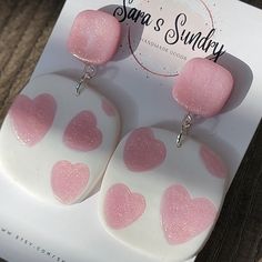 These fun color blocked heart earrings perfect for Valentines, Galentines or any day you want a pop of color. With the matte white background  the shimmery pink hearts really pop!  All of my earrings are designed and handmade by me. Making each and every one uniquely beautiful.  Made with lightweight polymer clay they are ultra-comfortable. Each earring is constructed with a stainless-steel nickel free post.  Made with Nickel Free lever back hoops. **The earrings in the picture are to showcase the style of earring. The earrings you receive will be different than the pictures above yet equally amazing. Fun Pink Heart-shaped Jewelry, Trendy White Heart-shaped Earrings, Heart-shaped Polymer Clay Earrings For Valentine's Day, Playful Pink Heart Earrings For Valentine's Day, Playful Pink Heart Earrings For Gift, Pink Heart-shaped Polymer Clay Earrings, Playful Pink Heart Earrings As Gift, Pink Polymer Clay Jewelry With Heart Beads, Valentine's Day Heart-shaped Polymer Clay Earrings