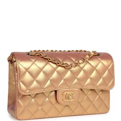 This Chanel small double flap bag is in gold iridescent metallic calfskin leather with antique gold tone hardware and features a front flap with CC turnlock closure, back half moon pocket and adjustable interwoven anitque gold chain link shoulder/crossbody strap.The interior is lined in gold metallic leather with the "love letter" zipper compartment under the first flap, an "outer" slit pocket under the second flap, and an interior compartment with two open pockets separated by a "lipstick" compartment.Collection: 2021 (RFID)Origin: FranceCondition: New and never (plastic on hardware) - one tiny scuff to into pocket.Accompanied by: Chanel Box, Chanel dustbag, carebook, RFIDMeasurements: 9" width x 5.25" height x 2.5" depth; 16.5" strap drop (9.5" doubled) Chanel Box, Chanel Bags, Metallic Leather, Flap Bag, Kids Bags, Half Moon, Crossbody Strap, Chanel Classic, Antique Gold