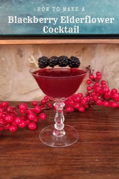 blackberry elderflower cocktail in a goblet with berries on the rim