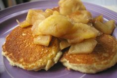 two pancakes on a plate with apple slices