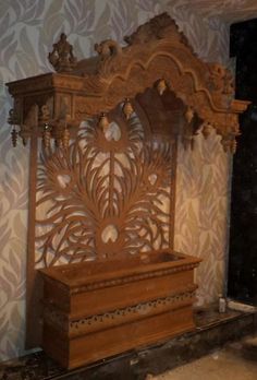 a wooden bench sitting in the middle of a room next to a wallpapered wall