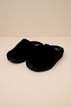 Slide through the day in maximum comfort (and style) thanks to the D'Amelio Footwear Socozee Black Faux Fur Flatform Slippers! Super soft and fuzzy faux fur shapes the perfect slipper silhouette with a rounded toe upper and a slide-on design. Matching faux fur lines the interior for extra-cozy wear, while the chunky, flatform-inspired heel completes the look. Available in whole sizes only. 1. 75" wrapped heel. Cushioned insole. Felted rubber sole has nonskid markings. Man Made Materials. Importe Black Fluffy Slippers For Winter, Black Slippers With Faux Fur Lining, Black Synthetic Slippers With Faux Fur Lining, Black Non-slip Slide Platform Slippers, Black Fur Slippers, Fuzzy Slippers, Black Faux Fur, Faux Fur, Slippers