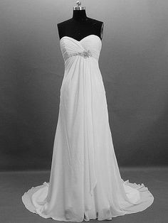 a white wedding dress on display in front of a gray background