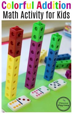 four lego blocks with numbers on them sitting on a table next to dices and pencils