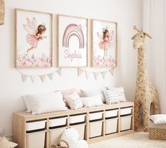 a child's room decorated in pink and white with pictures on the wall above