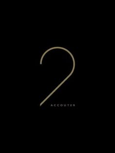 the number two in gold on a black background with an inscription that reads,'2 '