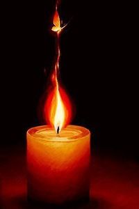 a lit candle on a red surface with a black background